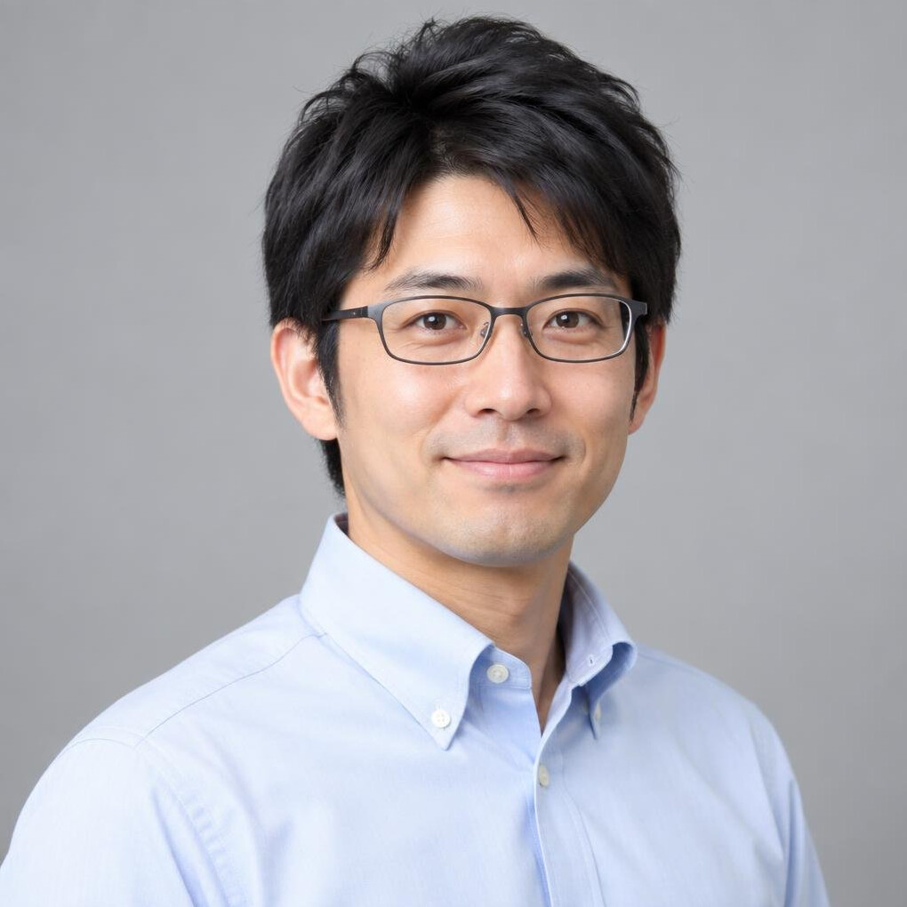 Studio portrait of a Japanese man in his 30s wearing glasses and a shirt
