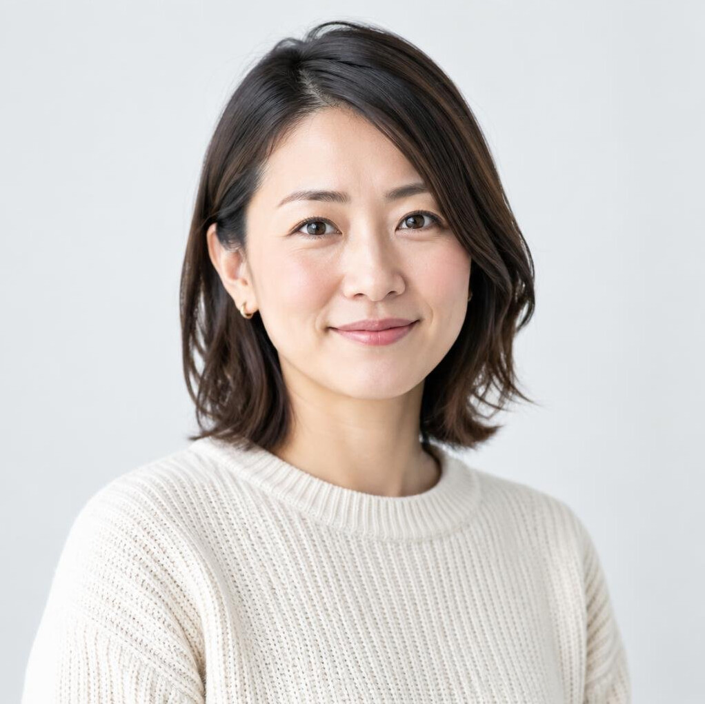 Studio portrait of a Japanese woman in her 30s wearing a knit sweater